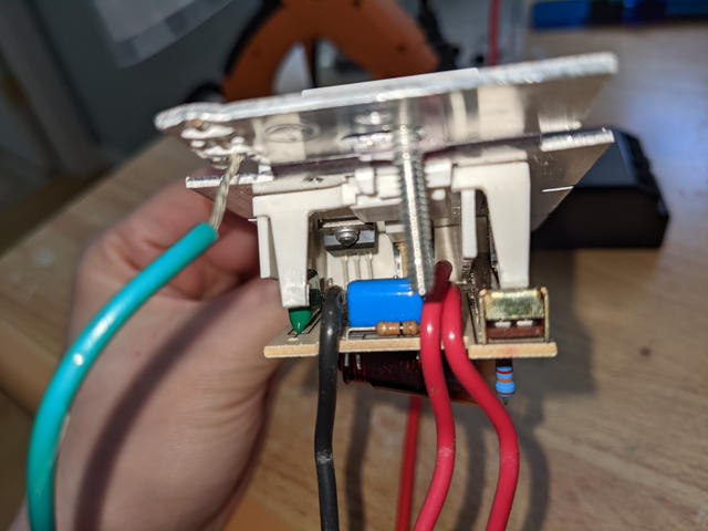 Looking under the PCB reveals a three-terminal semiconductor component bolted to the metal frame for heat dissipation.